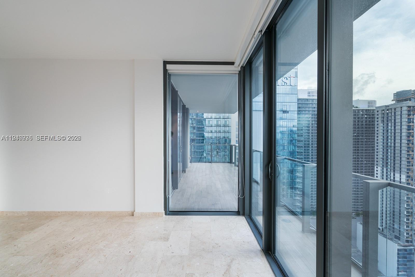 68 Southeast 6th Street, Unit 3402 Miami, FL 33131 - Photo 7 of 22 a view of a glass door and an entryway