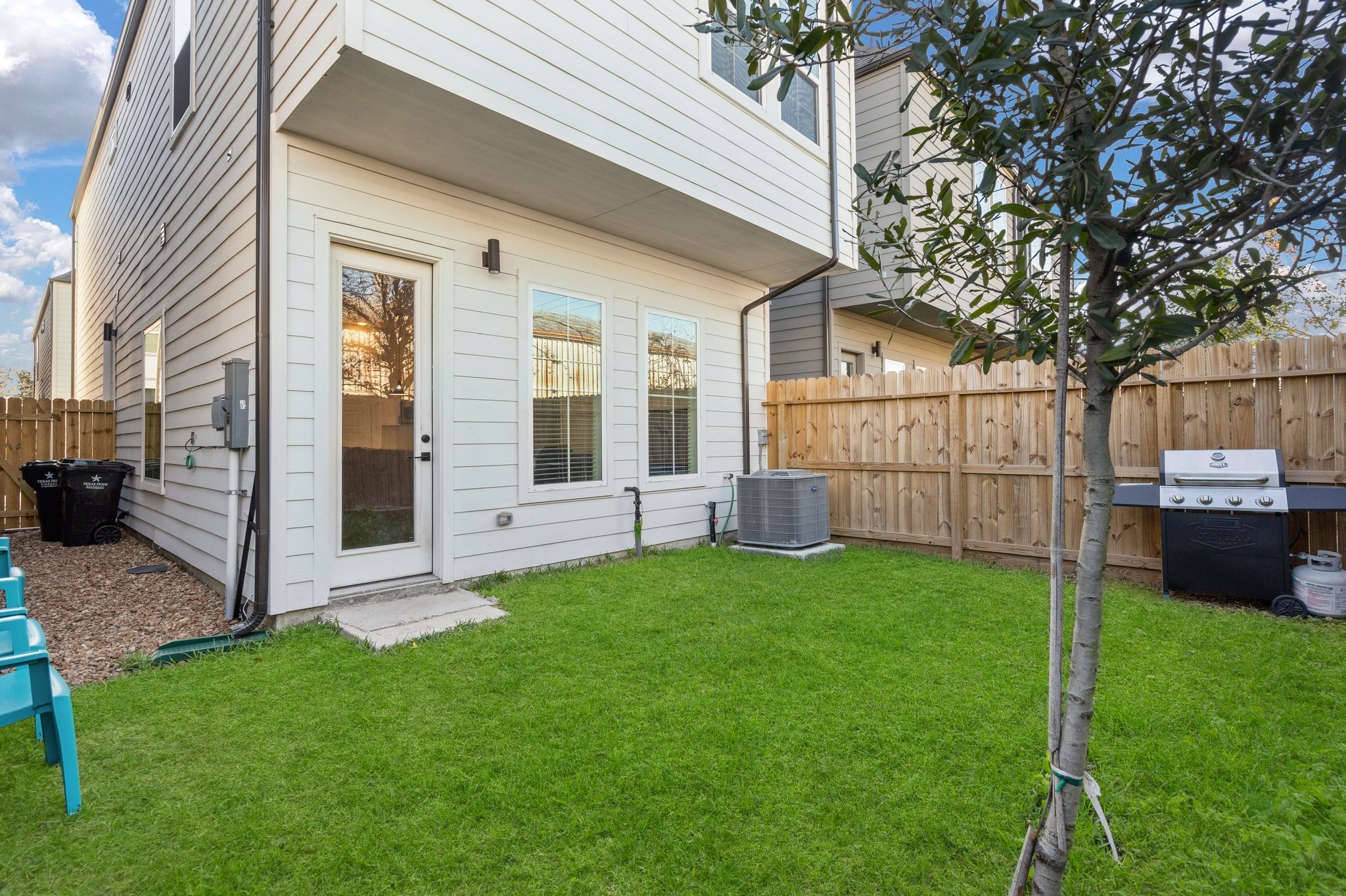 2928 Stevens Street Houston, TX 77026 - Photo 23 of 30 Compact backyard with a well-maintained lawn, small patio area, and a barbecue grill. The space is enclosed by a wooden fence, offering privacy. Ideal for outdoor relaxation and entertaining.