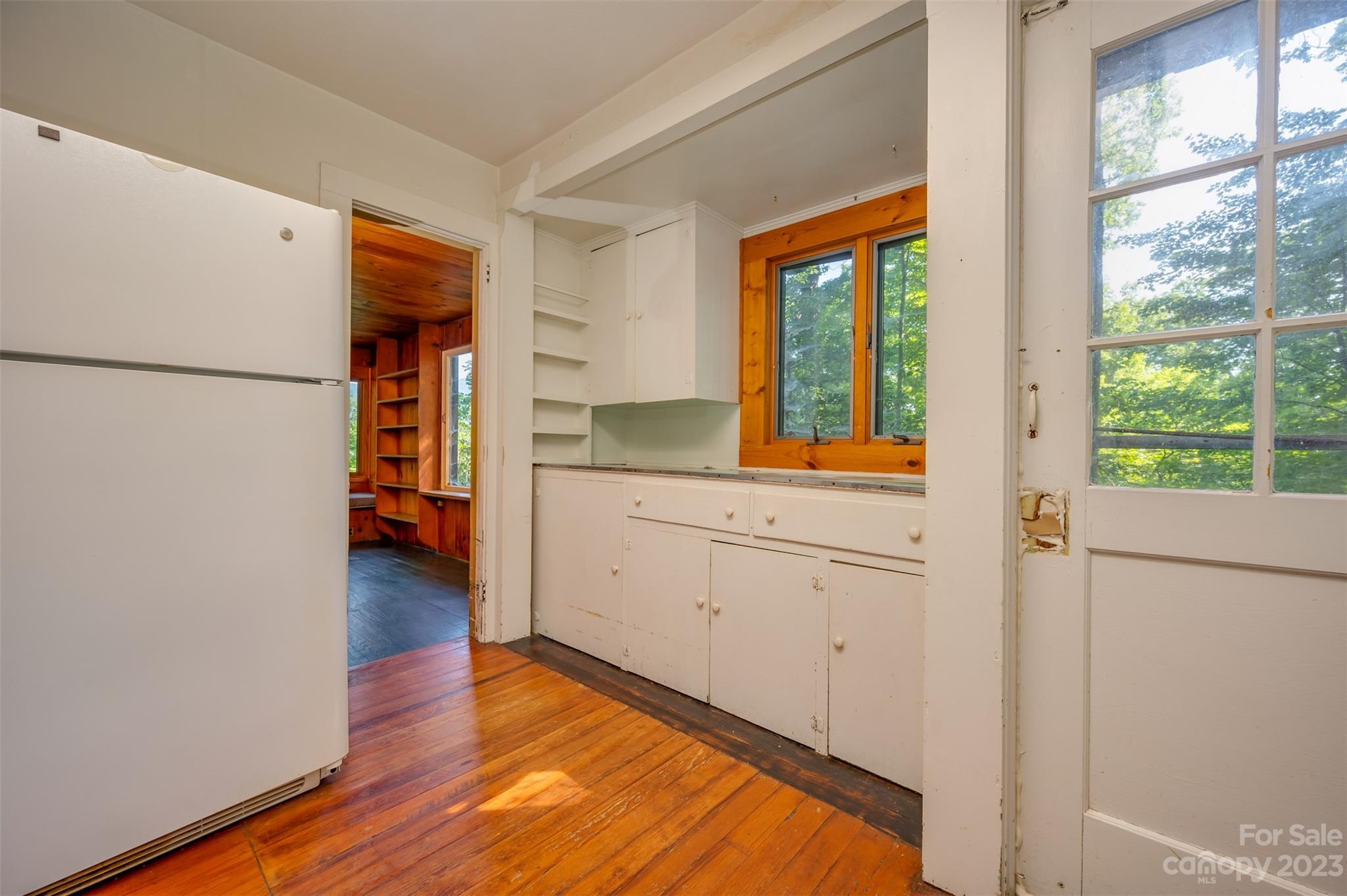 381 Wilderness Road Tryon, NC 28782 - Photo 11 of 46 a view of a kitchen with wooden floor and electronic appliances