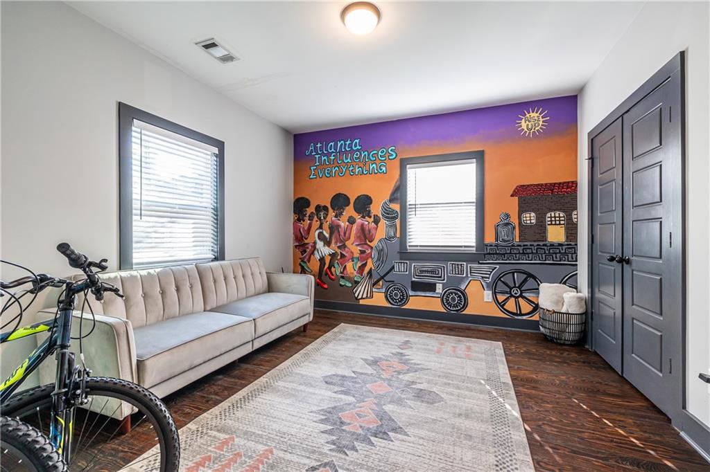 a living room with furniture a flat screen tv and a large window