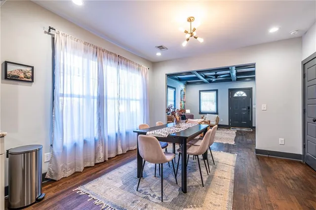 a dining room with furniture window and wooden floor