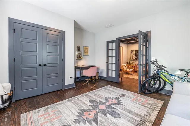 a bedroom with furniture and a wooden floor