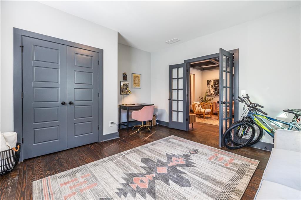 988 Mayson Turner Road Northwest Atlanta, GA 30314 - Photo 16 of 45 a bedroom with furniture and a wooden floor