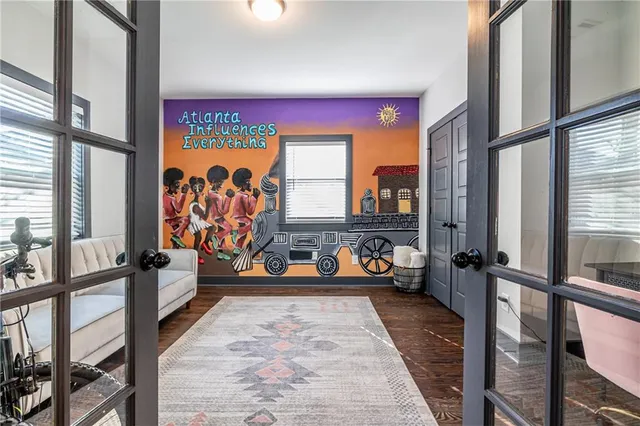 a view of a living room with furniture and a large window