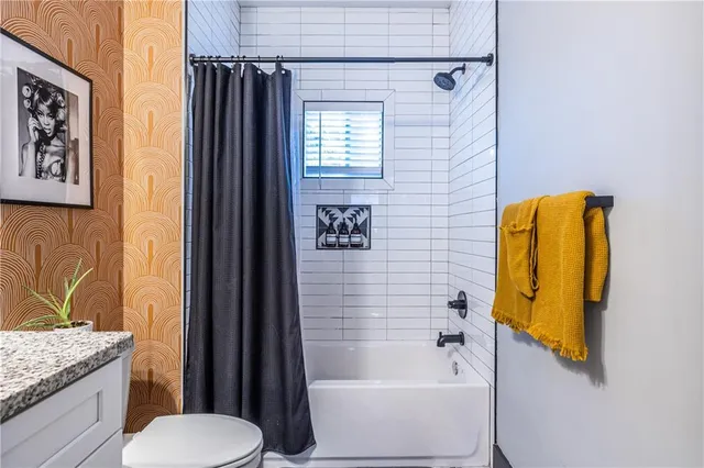 a bathroom with a tub sink and toilet