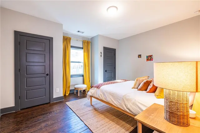 a bedroom with a bed and wooden floor