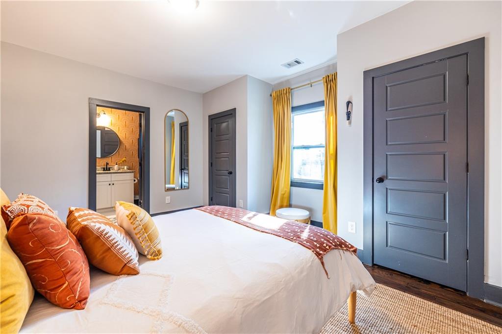 988 Mayson Turner Road Northwest Atlanta, GA 30314 - Photo 23 of 45 a bedroom with a bed and wooden floor