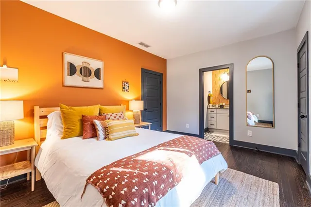 a bedroom with a bed and a mirror