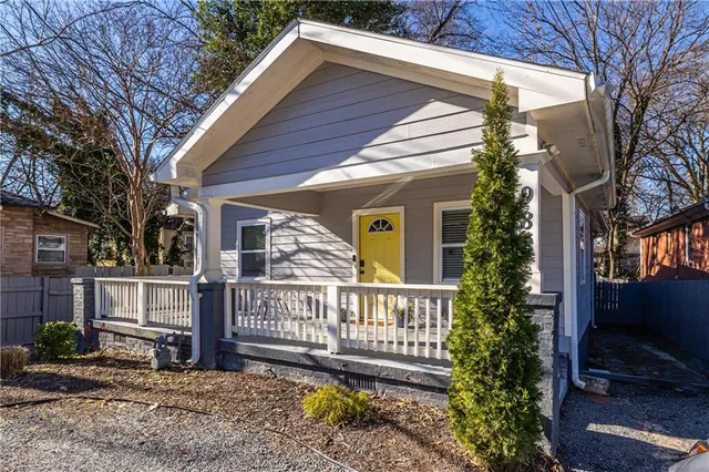 a view of a house with a yard and furniture