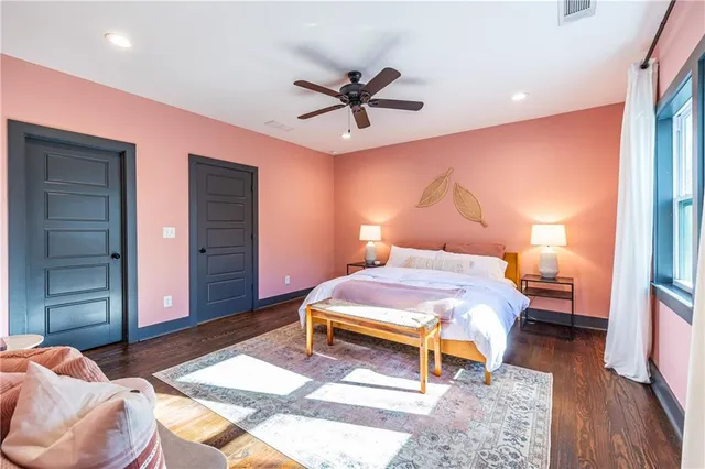 a bedroom with a bed and a mirror