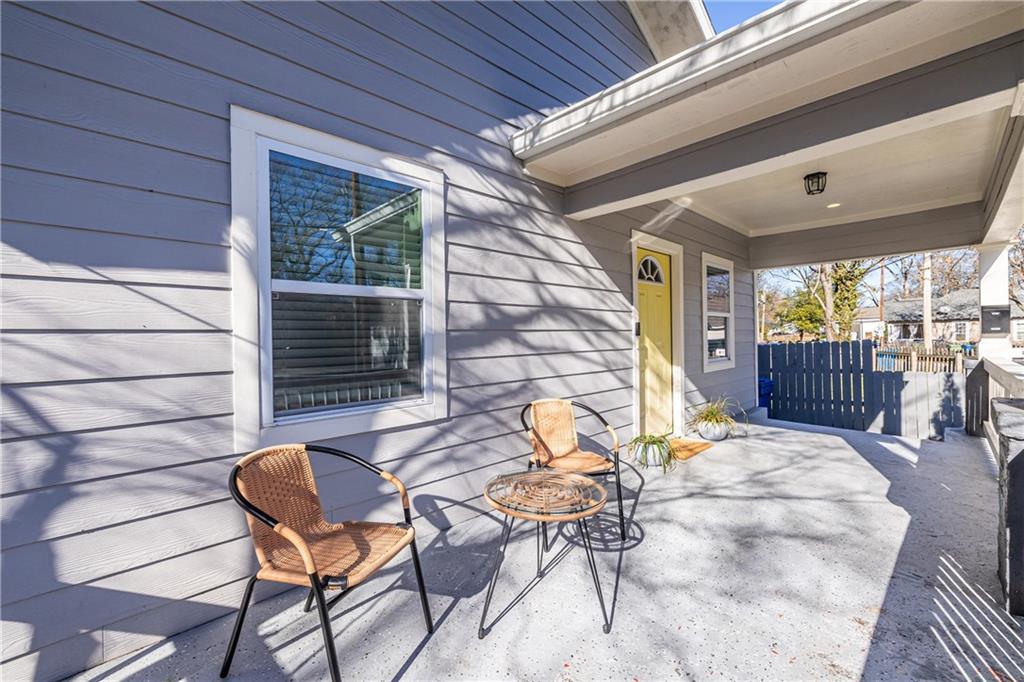 988 Mayson Turner Road Northwest Atlanta, GA 30314 - Photo 5 of 45 a view of a patio with table and chairs with wooden floor and fence