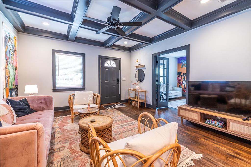 988 Mayson Turner Road Northwest Atlanta, GA 30314 - Photo 8 of 45 a living room with furniture a flat screen tv and kitchen view