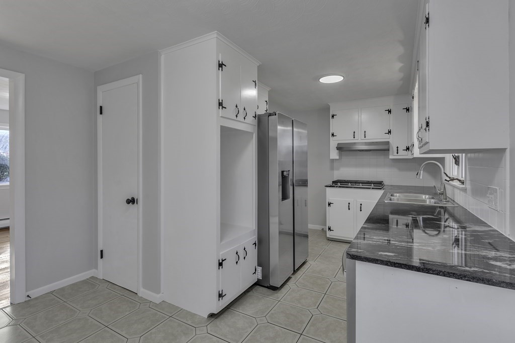 121 Herrman Street West Springfield, MA 01089 - Photo 17 of 40 a kitchen with stainless steel appliances granite countertop a refrigerator and a sink