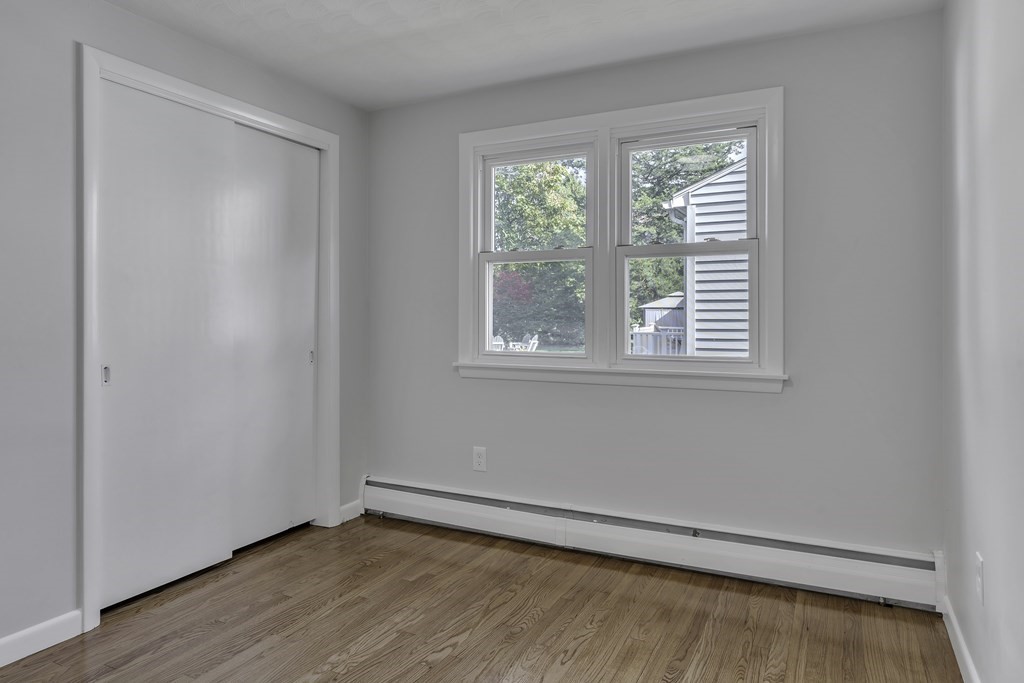 121 Herrman Street West Springfield, MA 01089 - Photo 8 of 40 a view of an empty room with wooden floor and a window