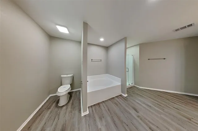 a bathroom with a toilet and a shower