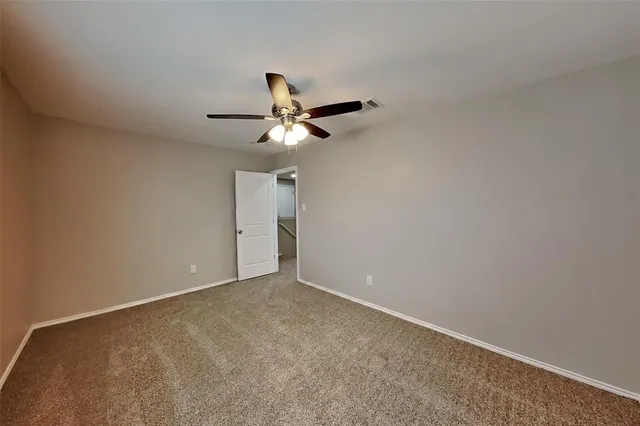 a view of room with a ceiling fan and window