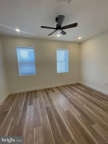 a view of an empty room and wooden floor