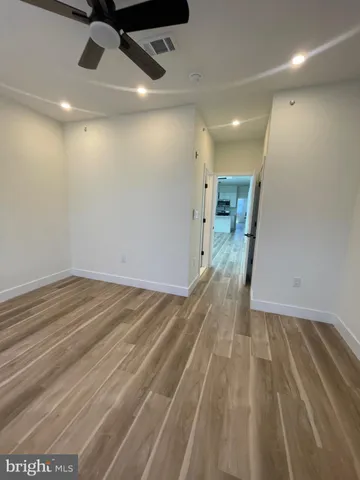 a view of hallway with a ceiling fan