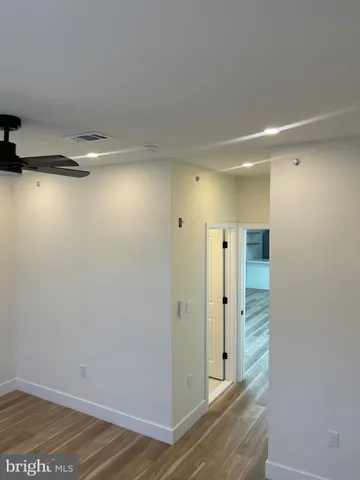 a bathroom with a granite countertop bathtub shower sink vanity and a toilet