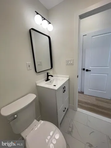 a bathroom with a toilet a sink and bathtub
