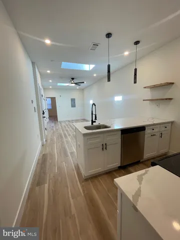 a kitchen with kitchen island sink stove and refrigerator