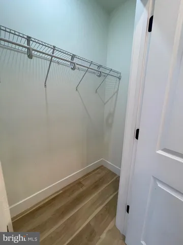 a view of a kitchen with a sink and dishwasher a refrigerator with wooden floor
