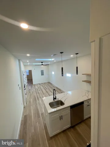a kitchen with a sink stainless steel appliances and cabinets