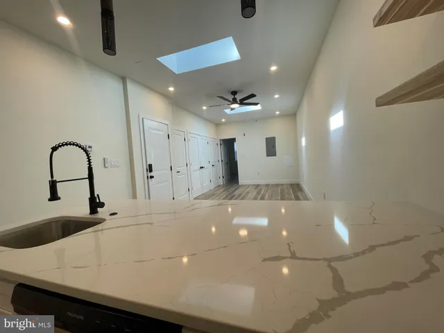 a kitchen with stainless steel appliances a sink a stove a microwave and cabinets