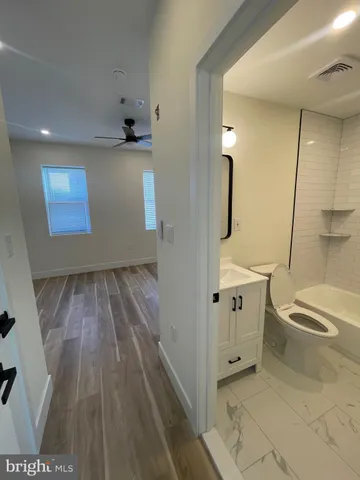 a bathroom with a sink a toilet a window and mirror
