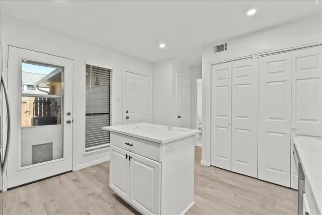 a view of a kitchen with white cabinets