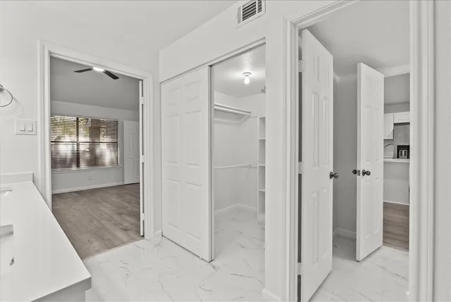 wooden floor with a bathroom and a mirror