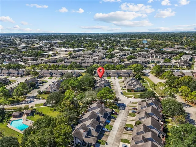 an aerial view of residential houses with city view
