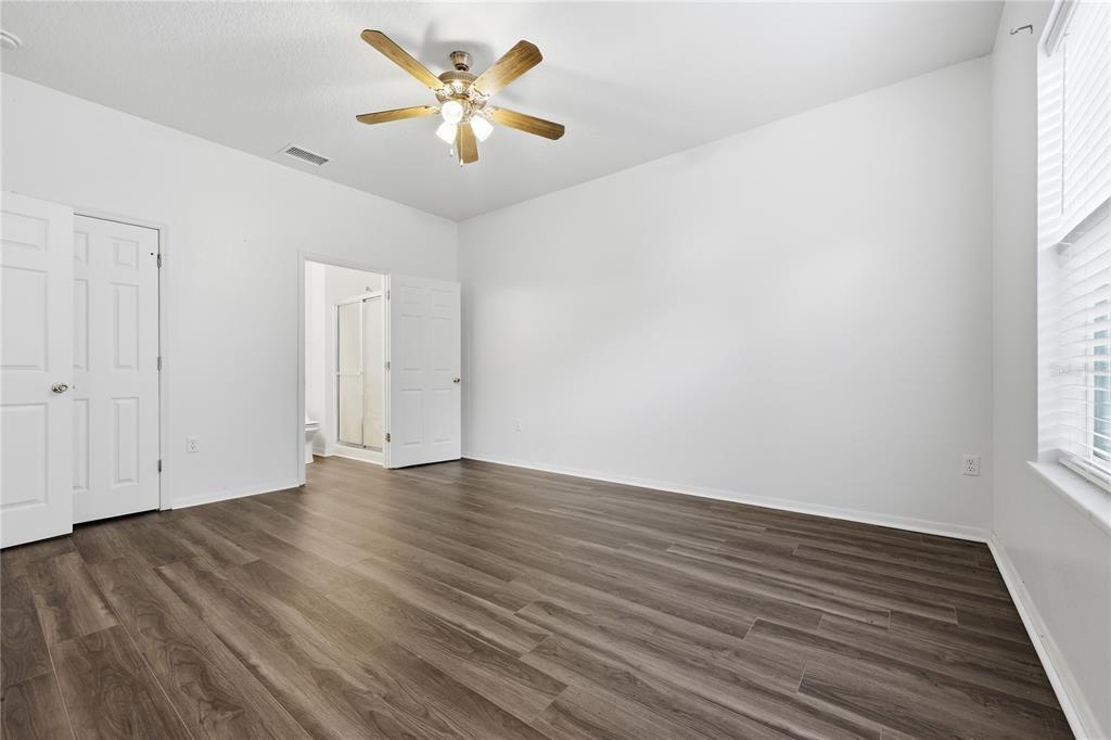 1348 Southwest 245th Way Newberry, FL 32669 - Photo 14 of 38 an empty room with wooden floor and window