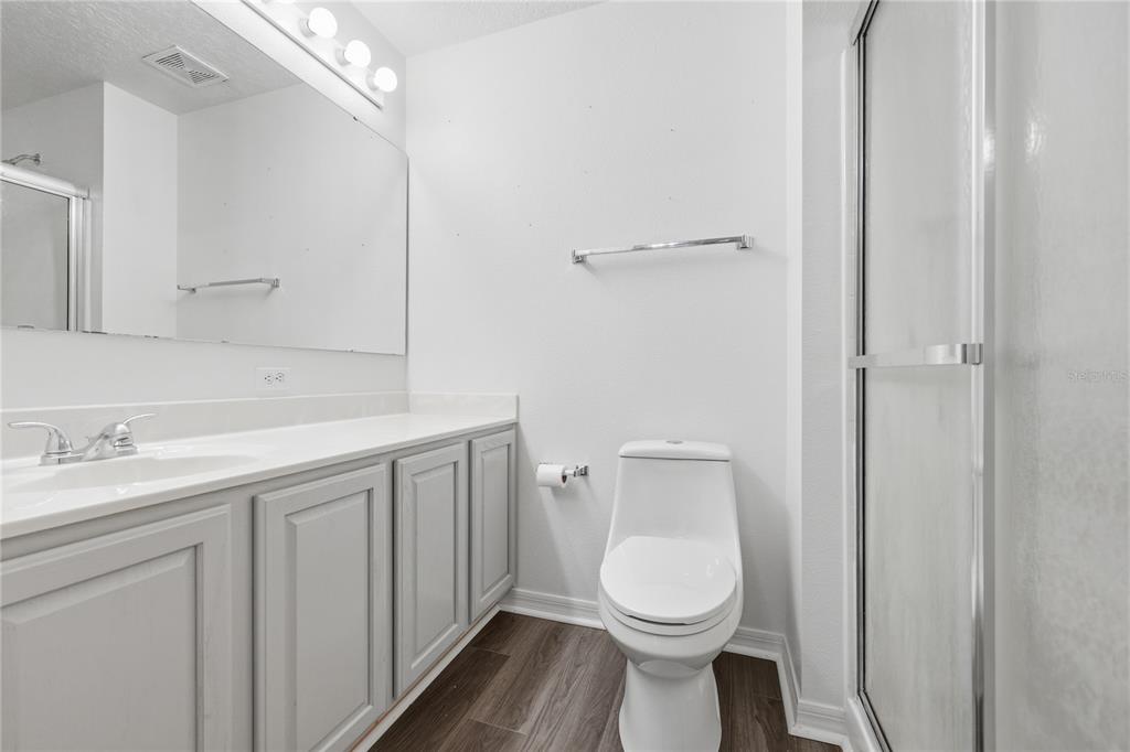 1348 Southwest 245th Way Newberry, FL 32669 - Photo 16 of 38 a bathroom with a toilet sink and mirror