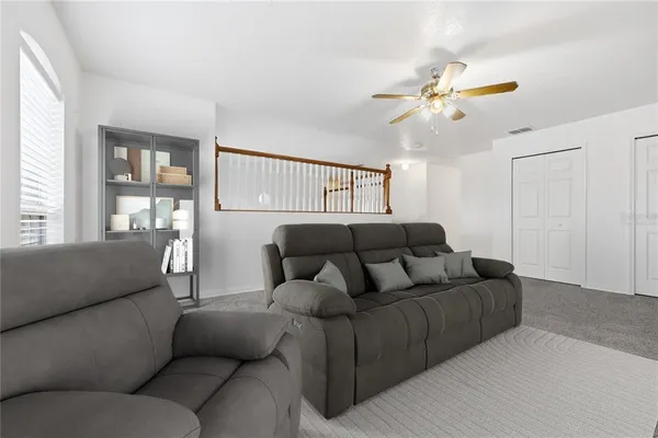 a living room with furniture and a large window