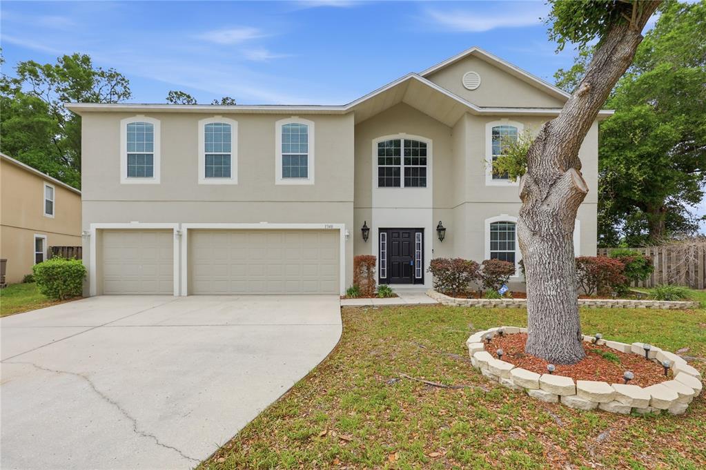 1348 Southwest 245th Way Newberry, FL 32669 - Photo 2 of 38 a front view of a house with a yard