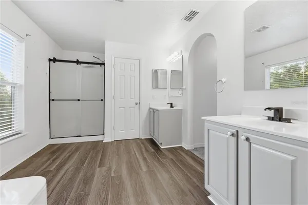 a view of a kitchen with a white cabinet and wooden floor