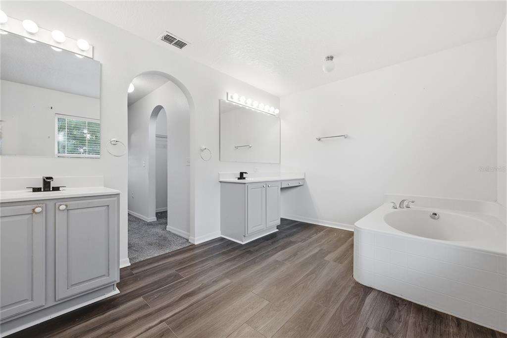 1348 Southwest 245th Way Newberry, FL 32669 - Photo 22 of 38 a view of a bathroom with tub sink and mirror