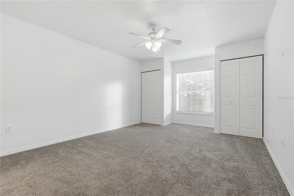 1348 Southwest 245th Way Newberry, FL 32669 - Photo 27 of 38 an empty room with windows and fan
