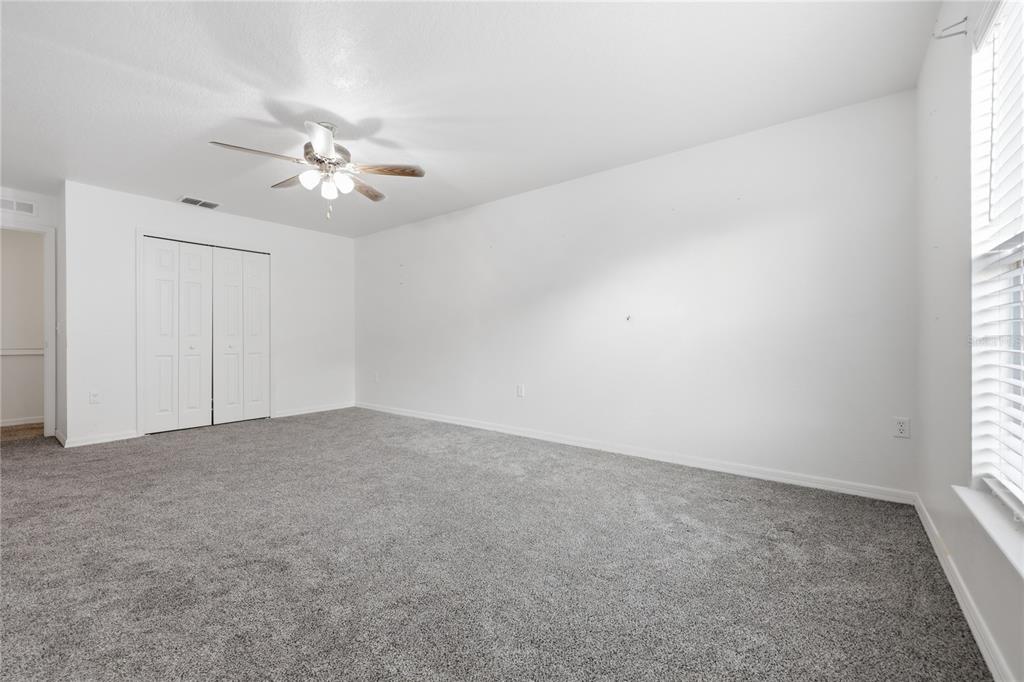 1348 Southwest 245th Way Newberry, FL 32669 - Photo 28 of 38 an empty room with a window and a ceiling fan