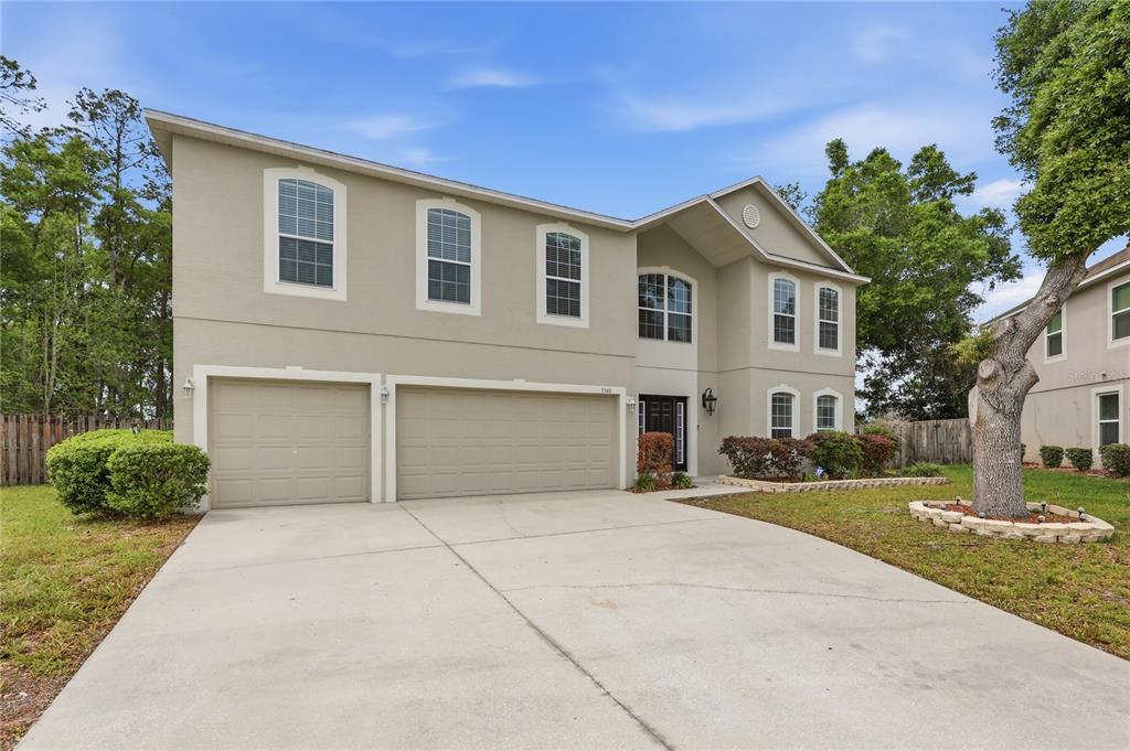 1348 Southwest 245th Way Newberry, FL 32669 - Photo 3 of 38 a front view of a house with a yard and garage