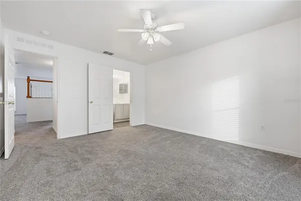 an empty room with fan and a ceiling fan