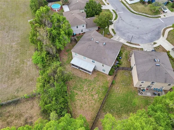 an aerial view of a house with garden space and a street view