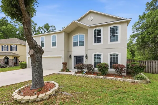 a front view of house with yard and green space