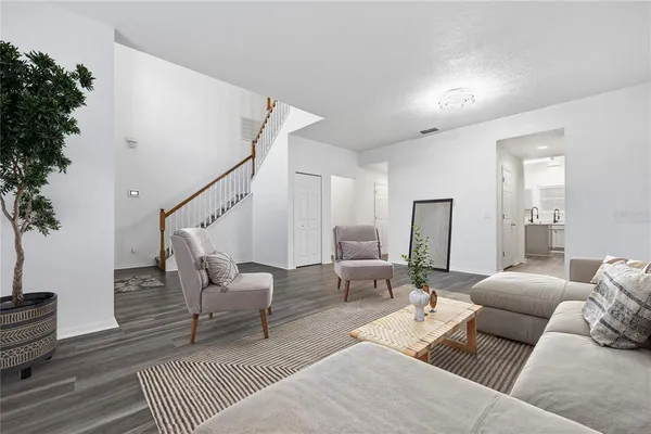 a living room with furniture and wooden floor