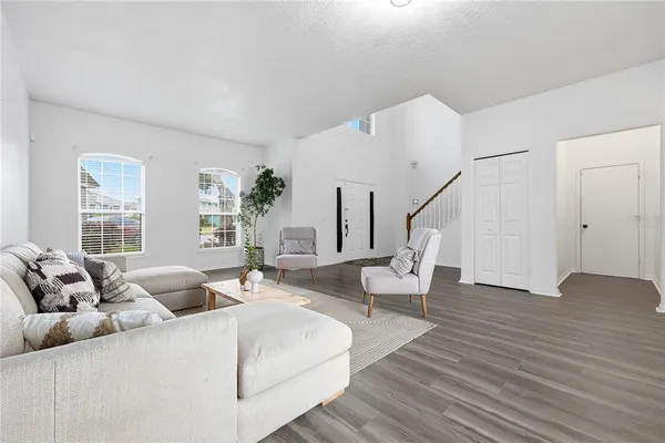 a living room with furniture and wooden floor