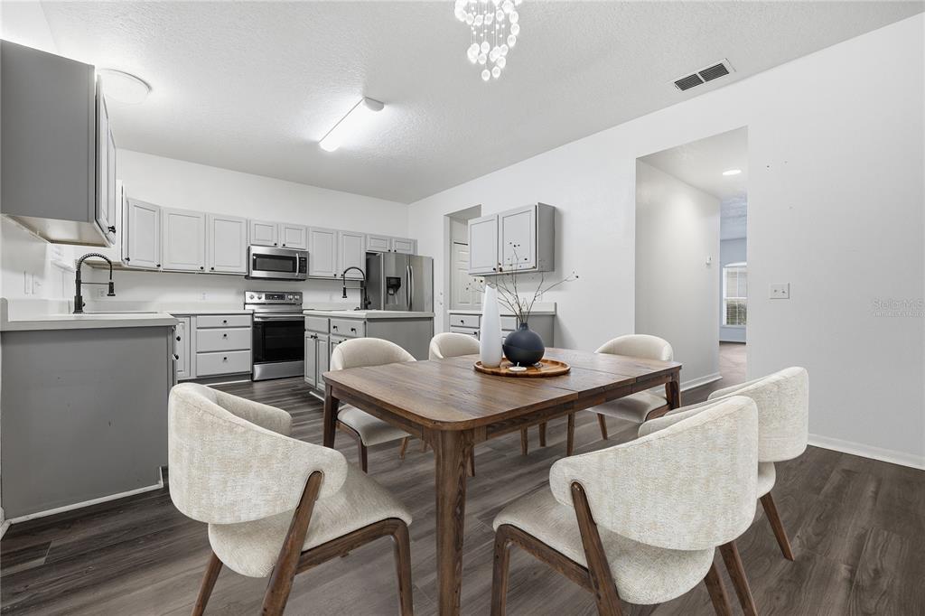 1348 Southwest 245th Way Newberry, FL 32669 - Photo 9 of 38 a view of kitchen with cabinets and wooden floor