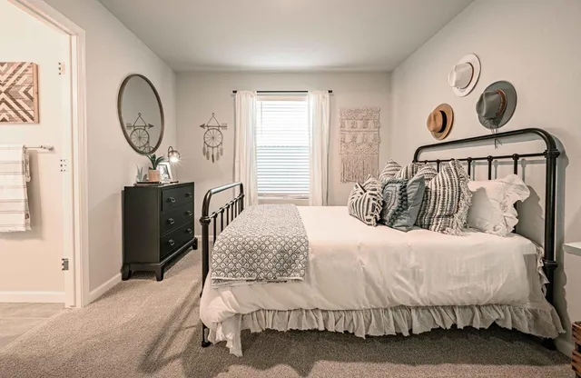 a bedroom with a bed and a chandelier