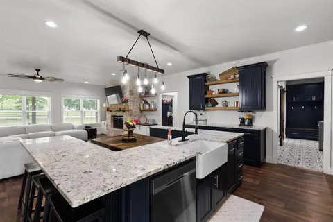 a kitchen with stainless steel appliances granite countertop wooden cabinets counter space and a sink