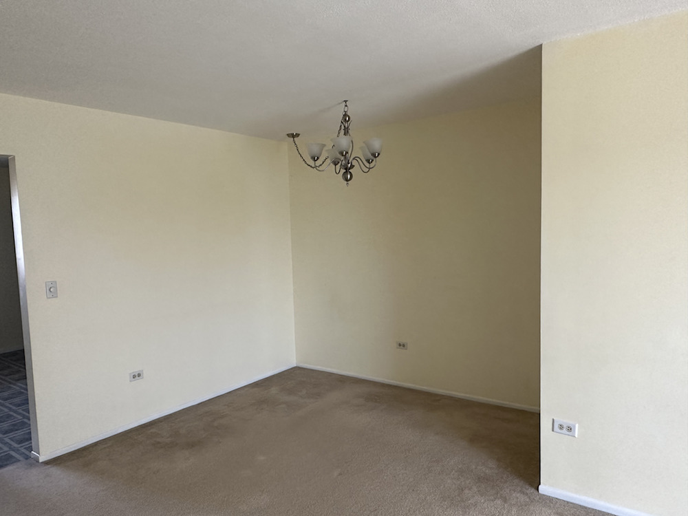 712 Cobblestone Circle, Unit E Glenview, IL 60025 - Photo 3 of 10 a view of a room with a ceiling fan and a window